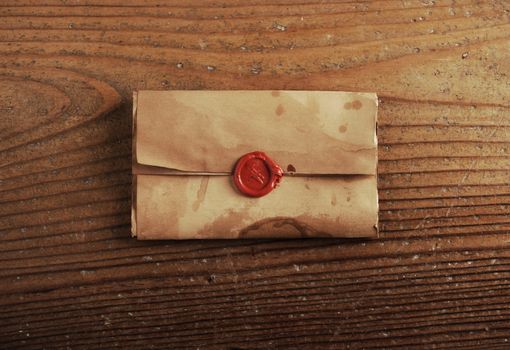 wax seal on a letter paper , background is wooden table