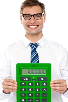 Smiling corporate man showing big green calculator against white background