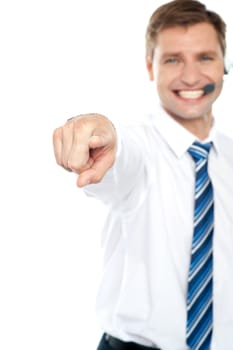 Cheerful male executive pointing at you isolated over white background