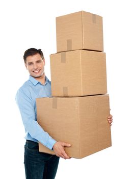 Happy young man carrying heavy packages against white background