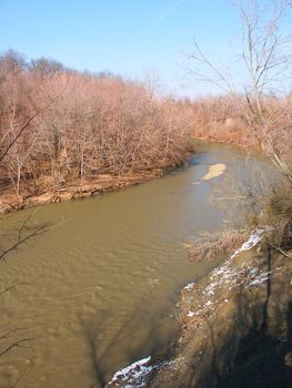 Vermilion River flows muddy and high through Kickapoo State Park in Illinois