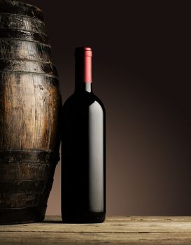 red wine bottle and wodden barrel