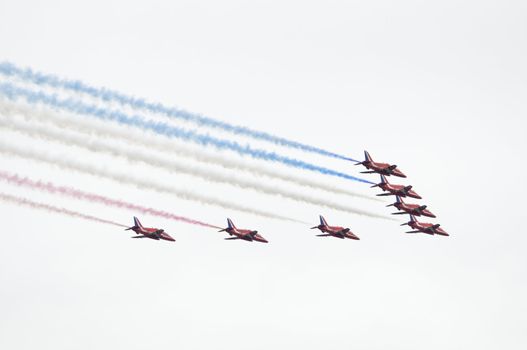 LONDON, UK, Saturday July 14, 2012. The Red Arrows from the Royal Air Force Aerobatic Team displaying at Farnborough International Airshow 2012. They fly on BAE Hawk Trainer T1A.