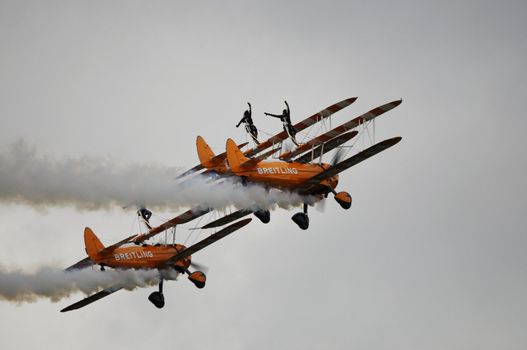 LONDON, UK, Saturday July 14, 2012. The Breitling Wingwalkers displaying at Farnborough International Airshow 2012. The Breitling Wingwalkers fly on Boeing-Stearman Model 75.