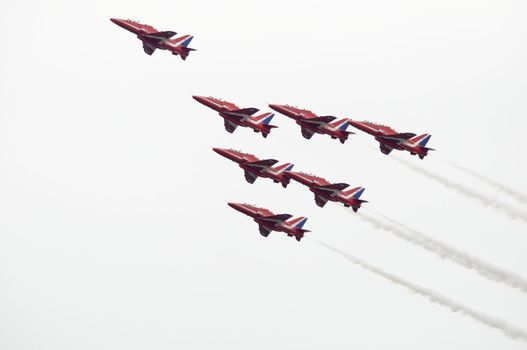 LONDON, UK, Saturday July 14, 2012. The Red Arrows from the Royal Air Force Aerobatic Team displaying at Farnborough International Airshow 2012. They fly on BAE Hawk Trainer T1A.