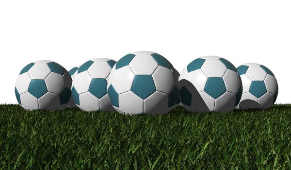 Cyan soccer balls on a green grass - black background