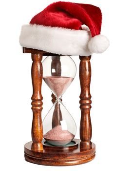 Christmas is coming concept - hourglass  with Santa Claus hat isolated on white background