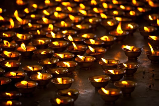 Burning candles in Buddhist temple. Tsuglagkhang complex,  McLeod Ganj, Himachal Pradesh, India