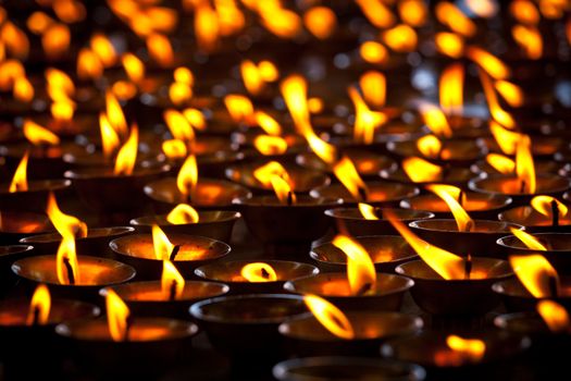 Burning candles in Buddhist temple. Tsuglagkhang complex,  McLeod Ganj, Himachal Pradesh, India