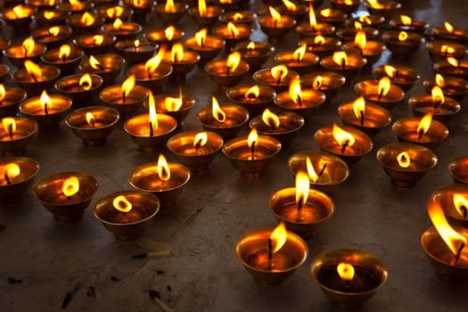 Burning candles in Buddhist temple. Tsuglagkhang complex,  McLeod Ganj, Himachal Pradesh, India