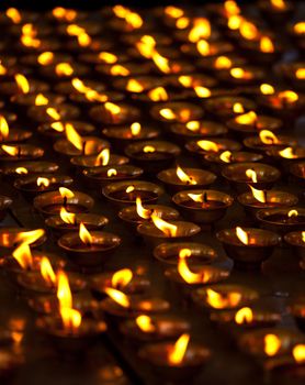 Burning candles in Buddhist temple. Tsuglagkhang complex,  McLeod Ganj, Himachal Pradesh, India