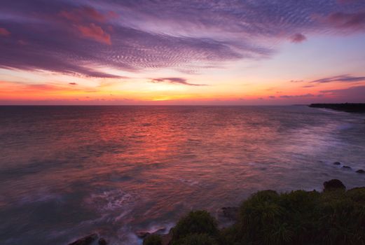 Ocean sunset on rocky coast. Varkala, Kerala, India