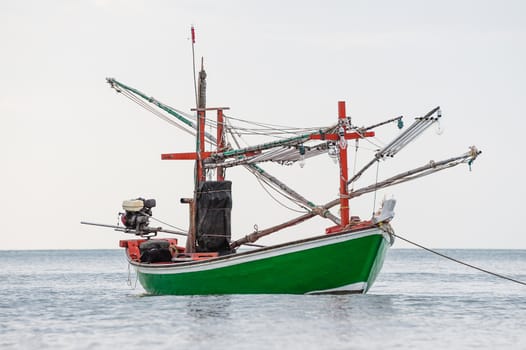 Green fishing boat thai on the sea in daylight time