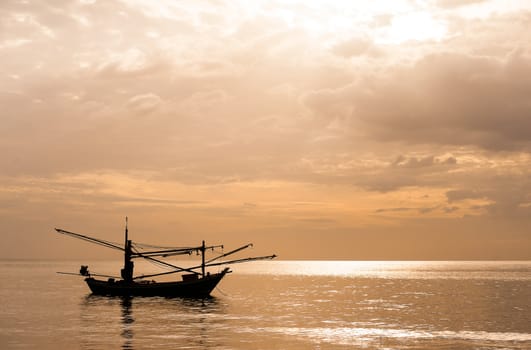 Green fishing boat thai silhouette on the sea in sunset time