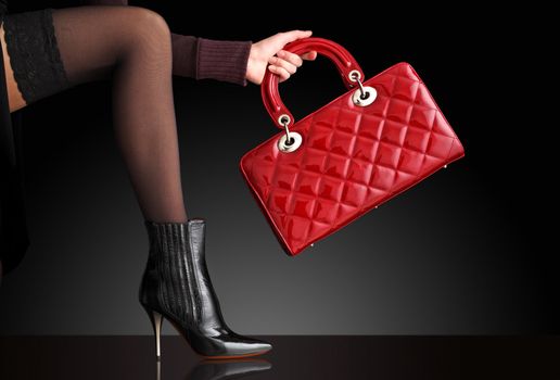 fashionable woman with a red bag, only legs