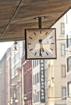 Street clock. Hanging clock on city walk.