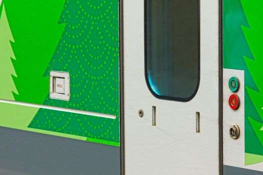 Closeup of stationary train with closed cars doors