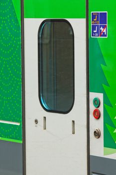 Closeup of stationary train with closed cars doors