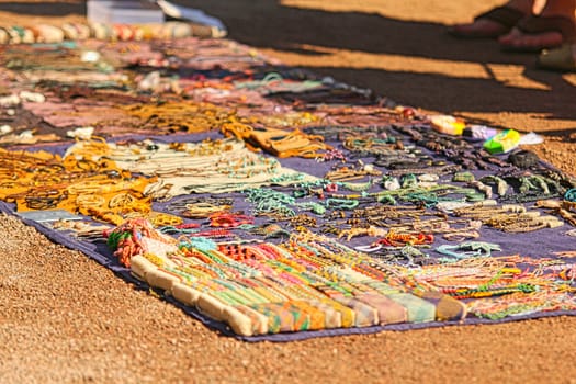 Assorted handmade jewelries on a carpet, at street market