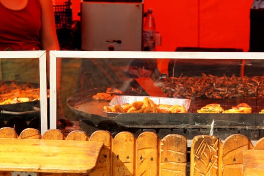 Chefs cooking at an outdoor restaurant, closeup