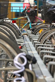 Bikes parked in the city, in a nice line into a rack