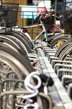 Bikes parked in the city, in a nice line into a rack