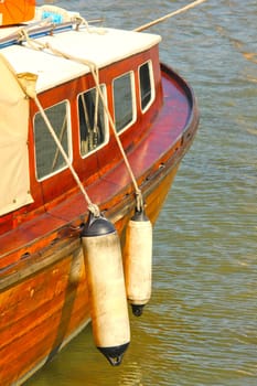 Side view of a wooden vintage boat in the harbor