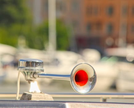 Fog horn mounted onto a boat, in harbor