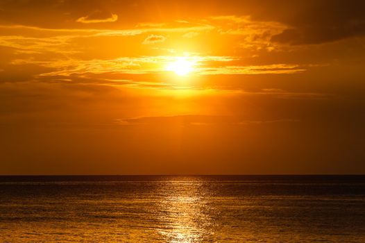 Sunset in the sea with soft wave and cloudy