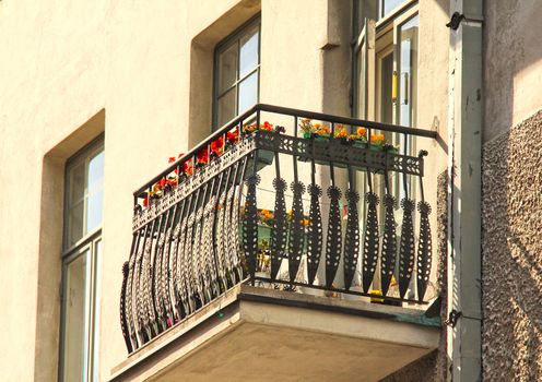 Balcnoy with flowers with a steel fenc on a concrete building