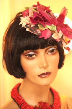 Doll woman portrait, with flowers in hair, towards yellow