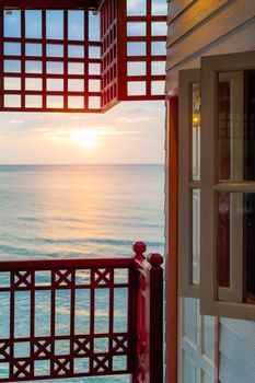 Sunrise in the sea with windows terrace view