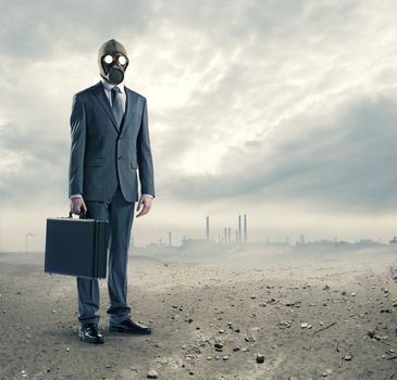 pollution concept: portrait of businessman in a gas mask  with suitcase