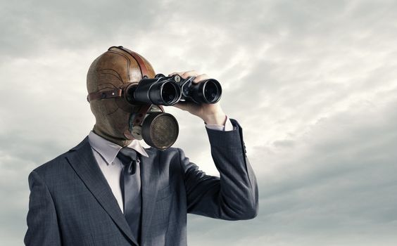 Businessman with gas mask  looking through binoculars