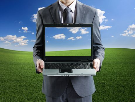 Businessman holding his laptop