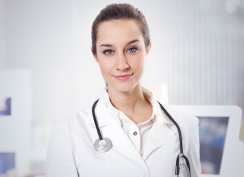 at pharmacy: portrait of  smiling young woman pharmacist with stethoscope