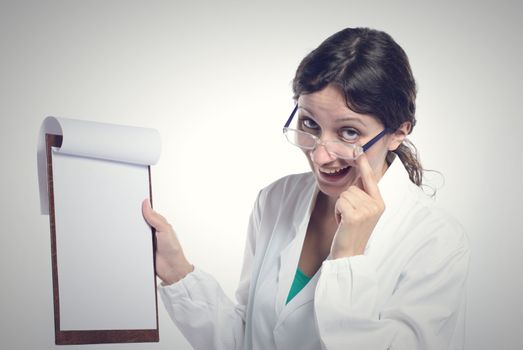 Female doctor holding blank clipboard. You can add your message to the clipboard.
