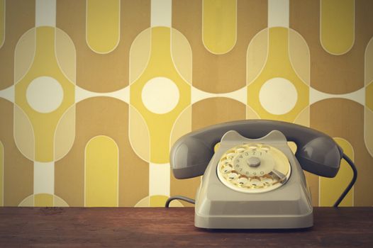 Old-fashioned phone on vintage background