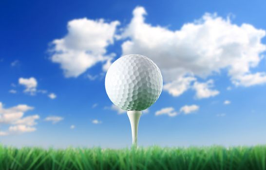 Golf ball in the grass against a  blue sky