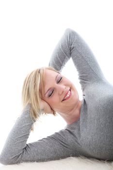 Satisfied blonde woman lying on white background