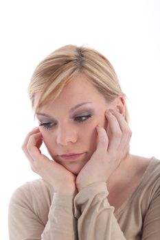 Portrait of disappointed blonde woman on white background