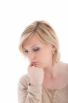 Sad dejected young woman with her chin resting on her hand as she recalls sad memories