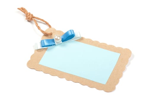 Blank tag tied with brown string. Price tag, gift tag, sale tag, address label, etc.