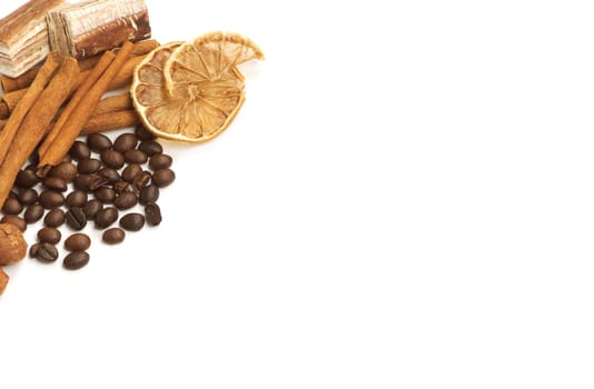 Coffee beans, cinnamon, lemon and sweets over white with a space for Your text