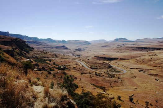 A winding road through Drakensberg mountain plains, Golden Gate National Park, South Africa.