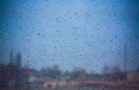 Drops Of Rain On Blue Glass Background