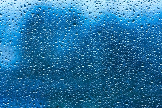 Drops Of Rain On Blue Glass Background