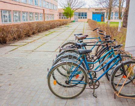 Five Old Bikes Bicycle Leaning On The Street. Belarus, Dobrush