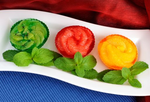 Jelly dessert of fresh fruit (oranges, grapefruit, kiwi) with mint