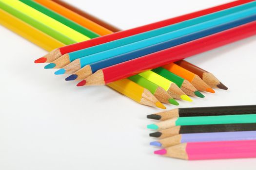 aranged wooden color pens on white background